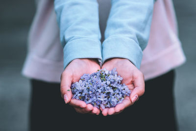 Midsection of woman holding flower