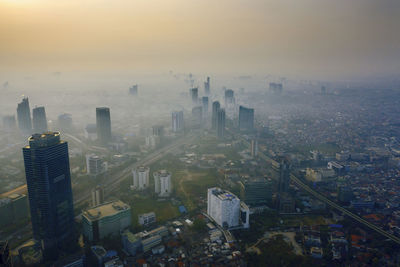 High angle view of city buildings during sunset