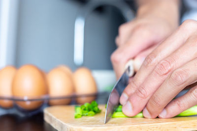 Close-up of person preparing food on table