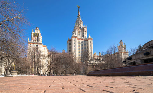 Red brick autumn road to the moscow university under blue sky