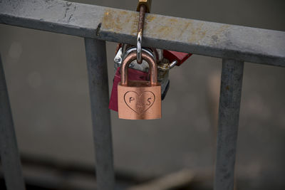 Close-up of padlocks on railing