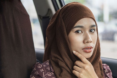 Close-up portrait of young woman looking away