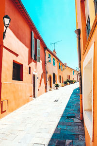 Walkway amidst buildings in city