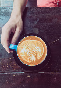 Midsection of coffee cup on table