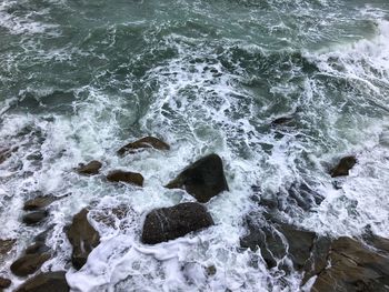 High angle view of rocks in sea