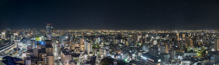 High angle view of city lit up at night