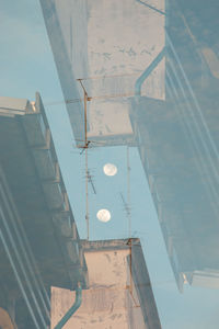 Low angle view of glass building against sky