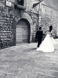 Full length of woman standing on railing