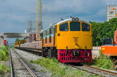 Train on railroad tracks against sky