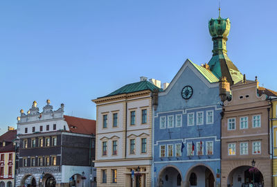 Low angle view of buildings against clear blue sky