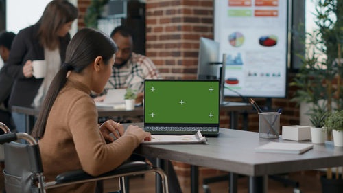 Young woman using laptop at table