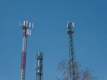 Low angle view of communications tower against blue sky