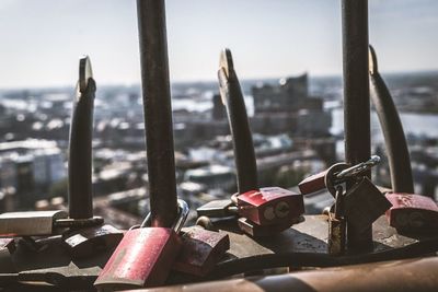 Close-up of padlocks on railing against river