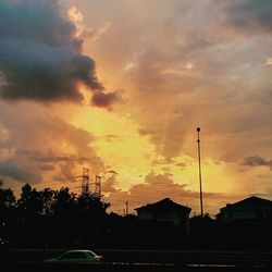 View of street light against cloudy sky at sunset