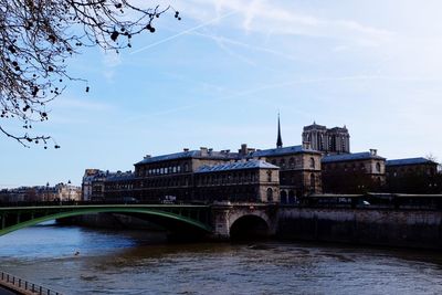 Bridge over seine river in city against sky