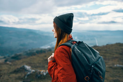 Man looking at mountain against sky