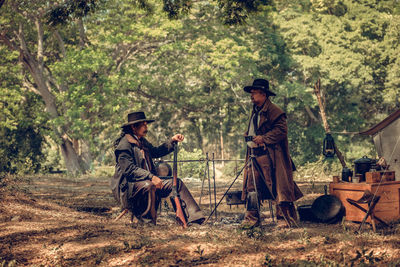 Male friends camping in forest