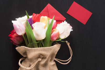 Close-up of flowers in sack over black background