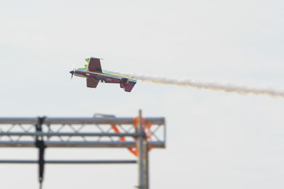 Low angle view of airplane flying against sky