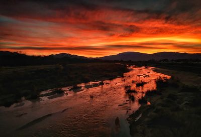 Scenic view of landscape against dramatic sky