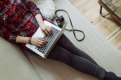 High angle view of woman using mobile phone at home