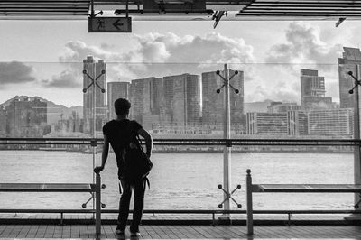 People standing by railing in city