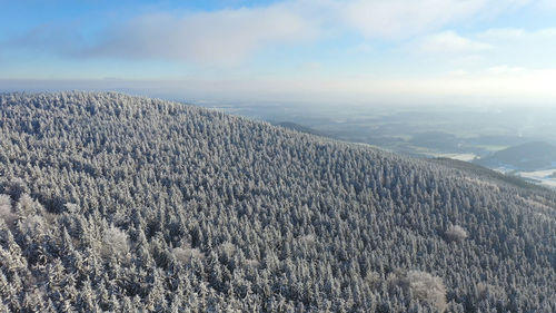 Scenic view of landscape against sky during winter