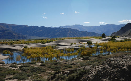 Scenic view of lake and mountains against sky