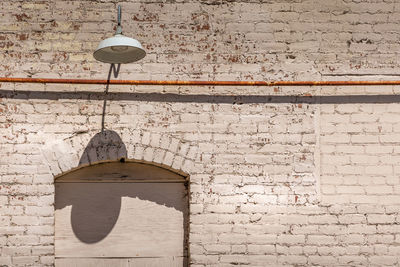 Low angle view of electric lamp on wall