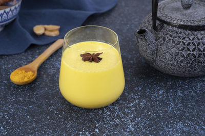 Golden milk. star anise is in a glass of turmeric moon milk. healthy drink.