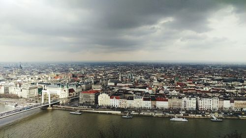 Cityscape against cloudy sky