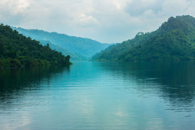 Scenic view of lake and mountains against sky