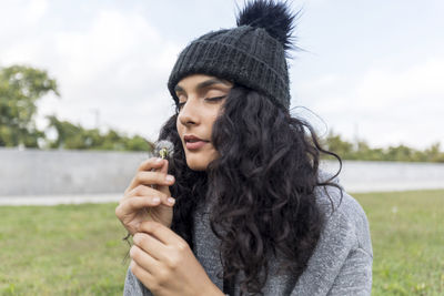 Portrait of young woman smoking cigarette