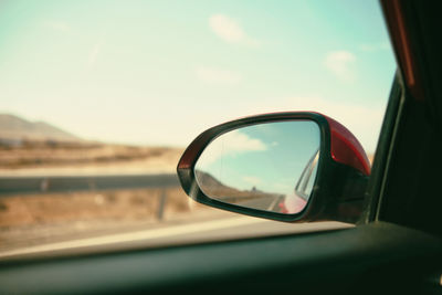Reflection of car on side-view mirror