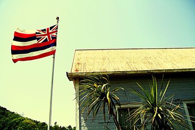 Low angle view of american flag against blue sky