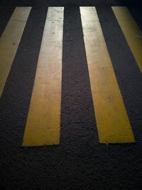 High angle view of yellow crossing sign on road