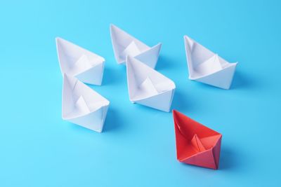 High angle view of paper flag against blue background
