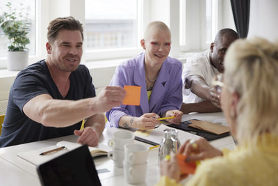 Diverse team brainstorming during business meeting in conference room