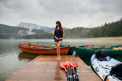 Woman standing on boat against sky