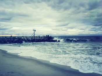 Scenic view of sea against cloudy sky