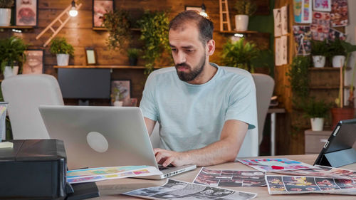 Man using laptop at table