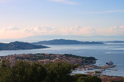 High angle view of townscape by sea against sky