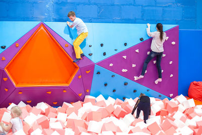 High angle view of people standing against blue wall