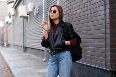 Young woman wearing sunglasses standing outdoors