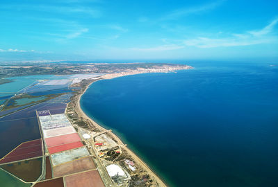 Aerial view of sea and salt pans against sky