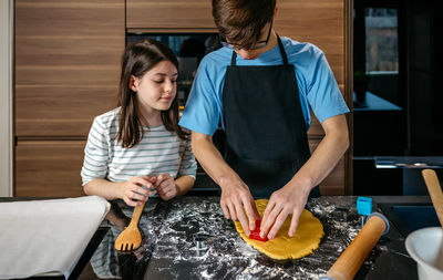 Rear view of young woman preparing food