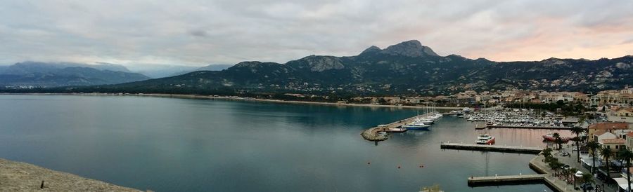 High angle view of boats in lake against cloudy sky