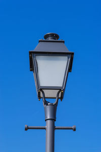 Low angle view of street light against clear blue sky