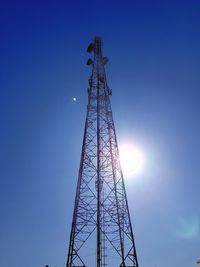 Low angle view of communications tower against blue sky