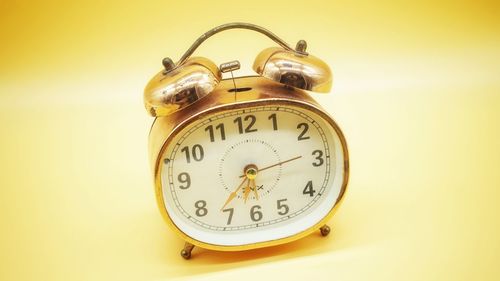 Close-up of alarm clock on table